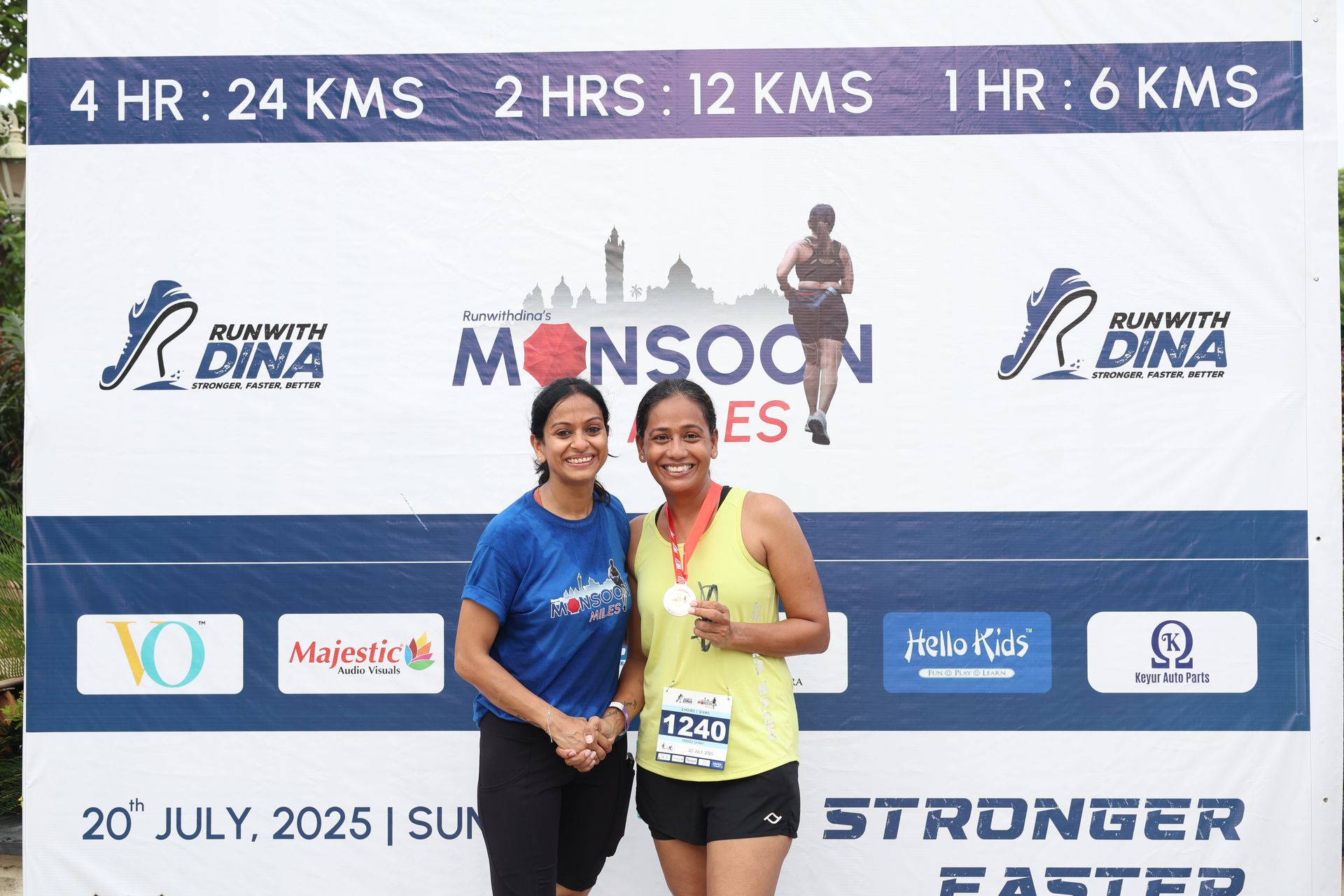 Dina with finisher at event backdrop