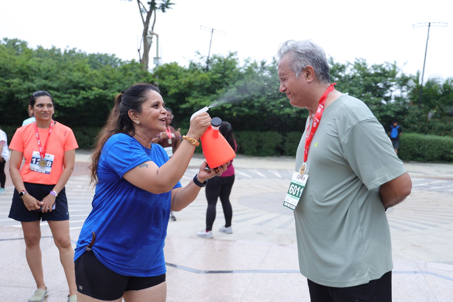 Dina spraying water on runner for fun