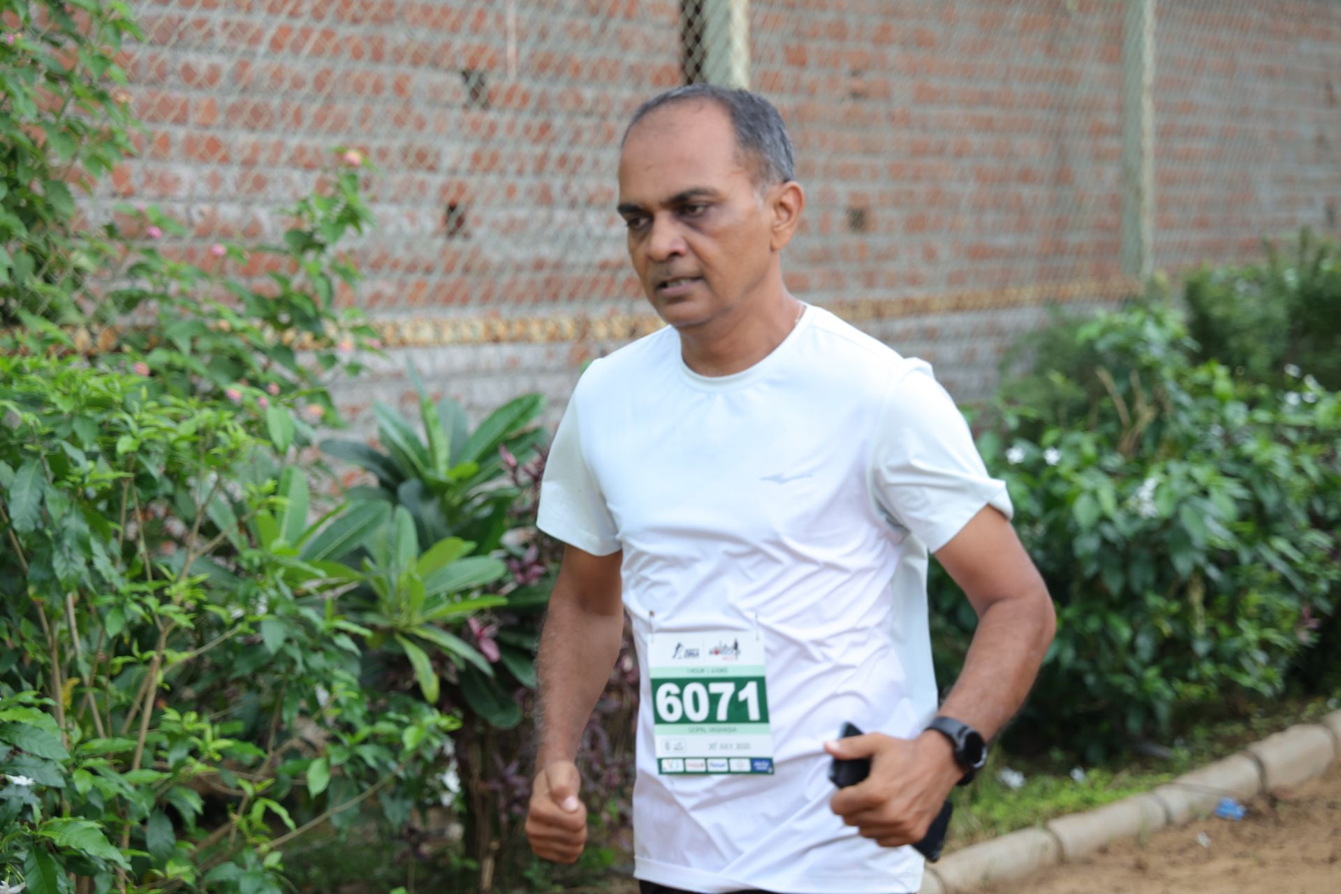 Focused runner on monsoon trail