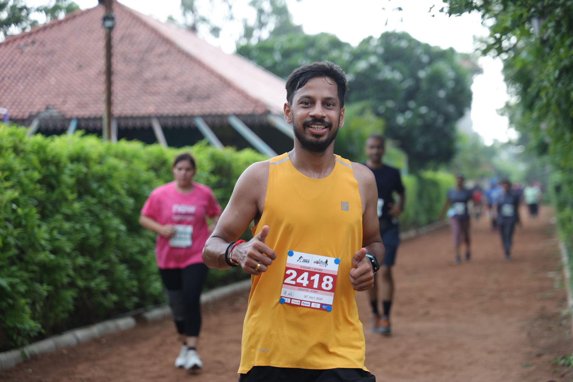 Runner in yellow giving thumbs up