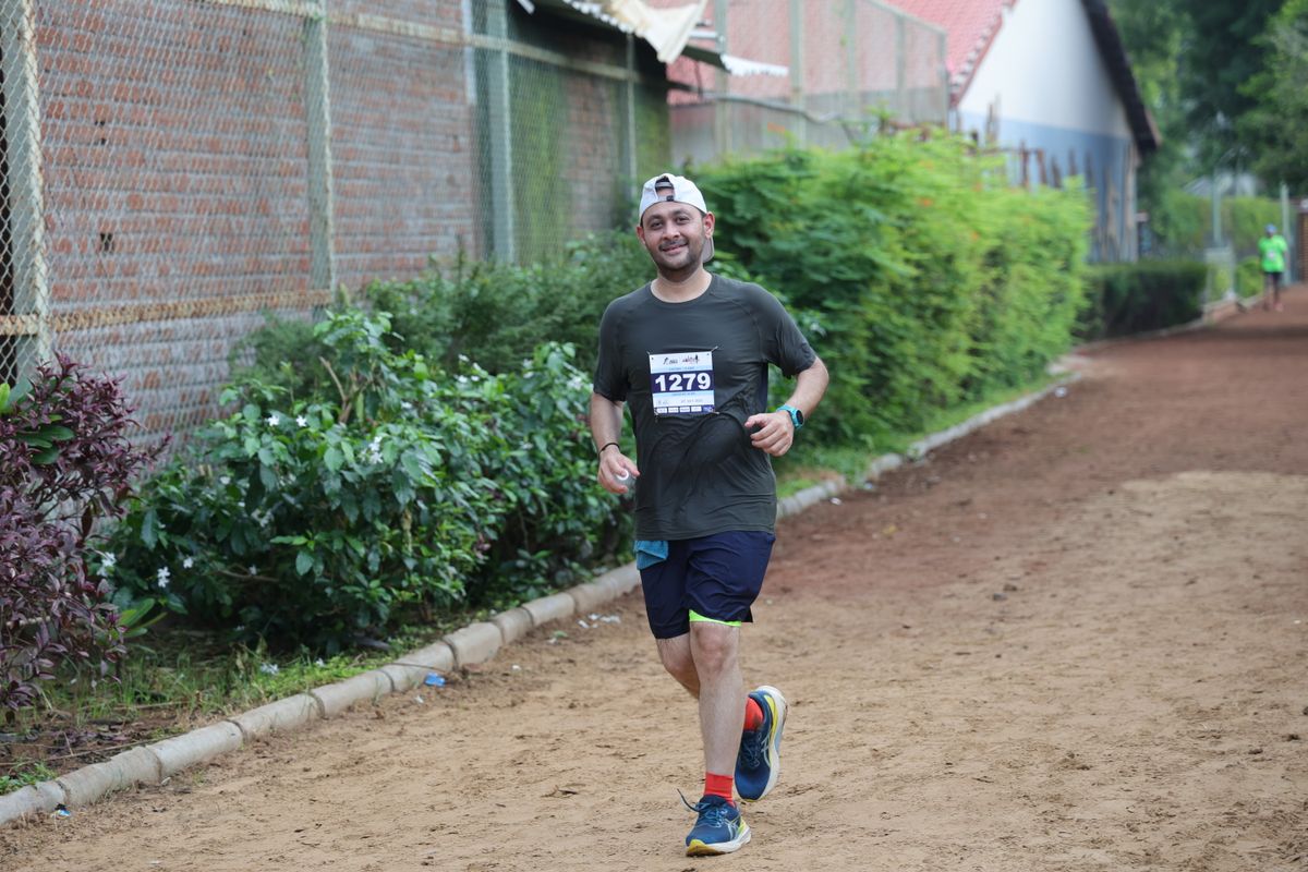 Smiling runner on the monsoon trail at Suncity Club and Resort during Monsoon Miles 2025