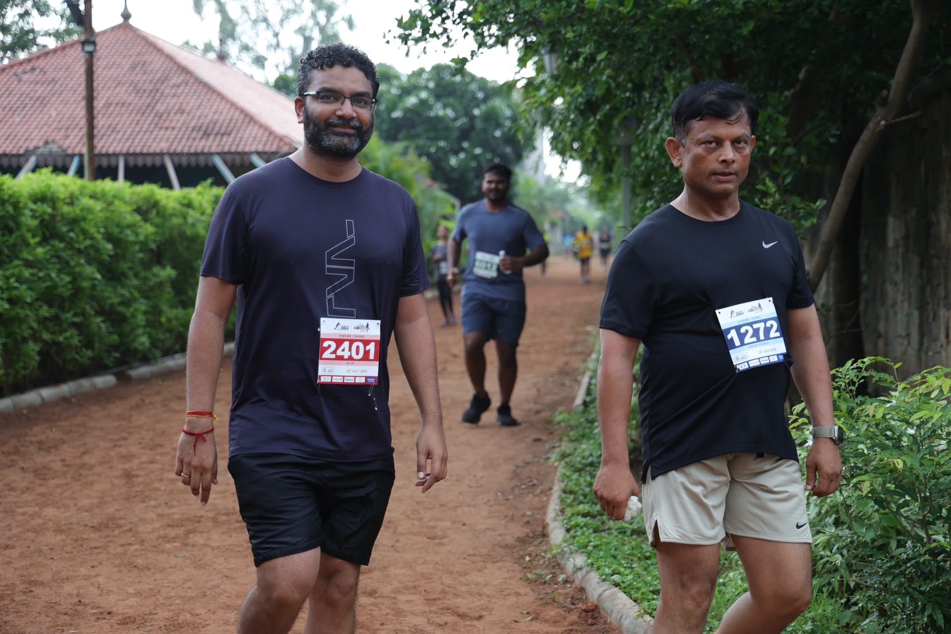 Two runners on misty trail
